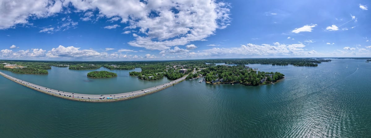 Aerial view of a lake and green shoreline near Kirkland with a highway crossing
