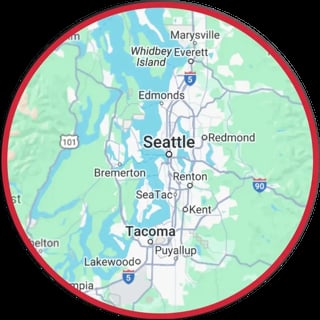 Map of Seattle and surrounding Washington cities including Tacoma, Edmonds, and Redmond within a red circle border